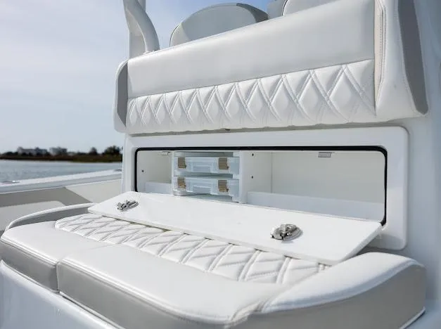  Yacht Photos Pics 2025 Yellowfin 34 Offshore boat with white cushioned seating and storage compartment.