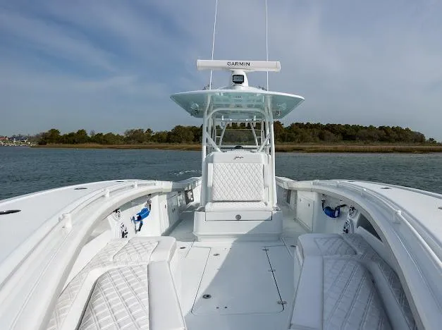  Yacht Photos Pics 2025 Yellowfin 34 Offshore boat on calm water, featuring spacious deck and modern design.