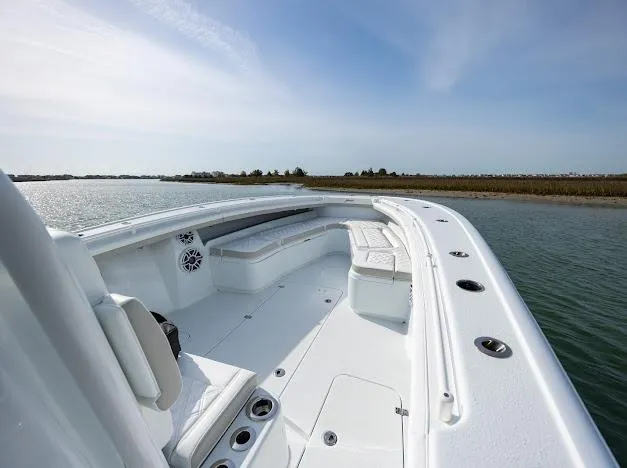  Yacht Photos Pics 2025 Yellowfin 34 Offshore boat, spacious deck, sleek design, on calm water.