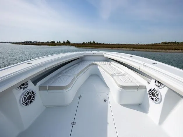  Yacht Photos Pics 2025 Yellowfin 34 Offshore boat with spacious seating and sleek design on calm water.