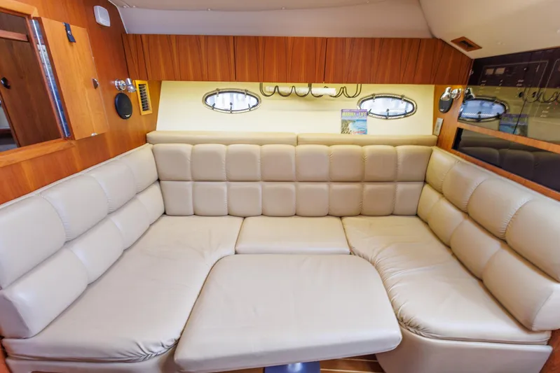 Last Call Yacht Photos Pics Luxurious interior of 2001 Tiara Yachts 3500 Open with plush seating and wood accents.