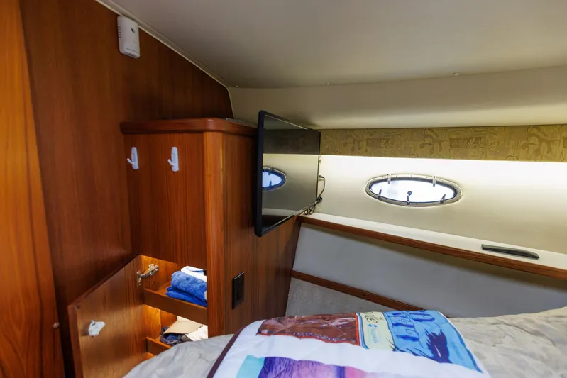 Last Call Yacht Photos Pics 2001 Tiara Yachts 3500 Open cabin interior with wood cabinetry and porthole window.