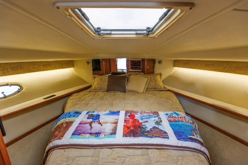Last Call Yacht Photos Pics Cozy cabin interior of 2001 Tiara Yachts 3500 Open with decorative bedding and skylight.