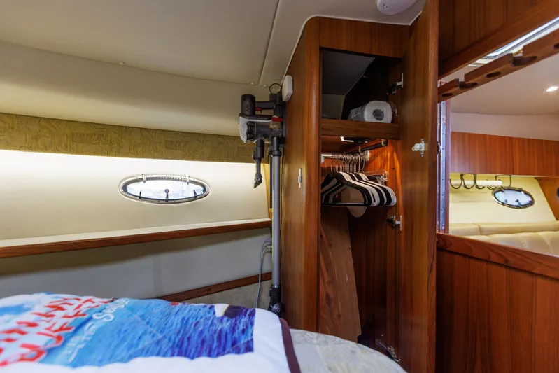 Last Call Yacht Photos Pics Interior of 2001 Tiara Yachts 3500 Open, featuring wooden closet and porthole window.