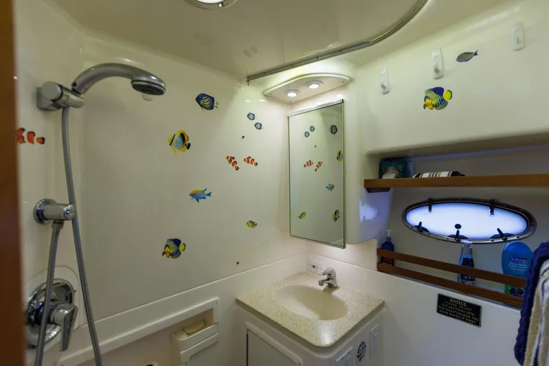 Last Call Yacht Photos Pics Bathroom of 2001 Tiara Yachts 3500 Open with fish-themed decor and modern fixtures.