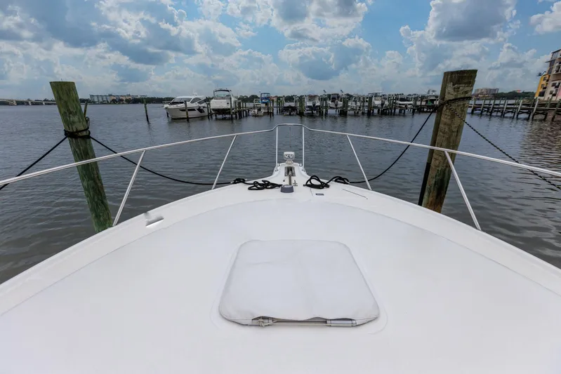 Last Call Yacht Photos Pics 2001 Tiara Yachts 3500 Open docked at marina under cloudy sky.
