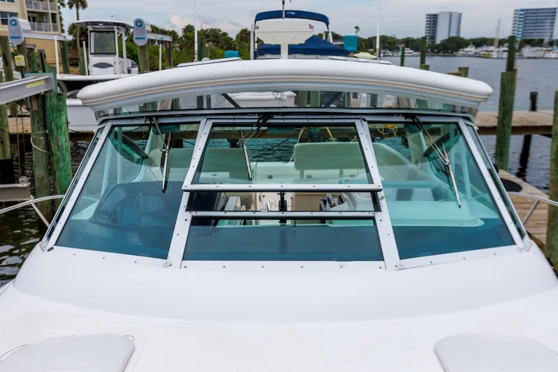 Last Call Yacht Photos Pics 2001 Tiara Yachts 3500 Open docked, showcasing front windshield and marina background.
