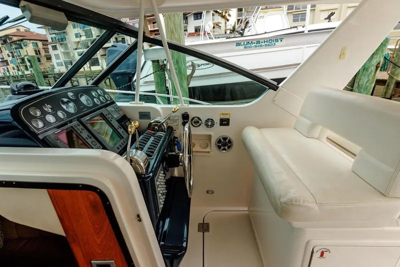 Last Call Yacht Photos Pics 2001 Tiara Yachts 3500 Open helm with controls and seating, docked at marina.