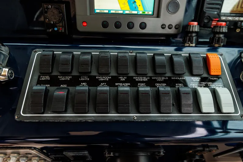 Last Call Yacht Photos Pics Control panel of a 2001 Tiara Yachts 3500 Open, featuring various switches and navigation equipment.