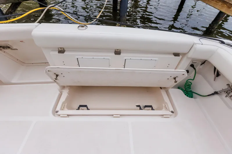Last Call Yacht Photos Pics 2001 Tiara Yachts 3500 Open boat storage compartment with open hatch, dockside view.