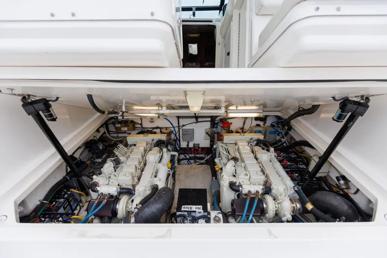 Last Call Yacht Photos Pics Engine compartment of 2001 Tiara Yachts 3500 Open, showcasing dual engines and mechanical components.