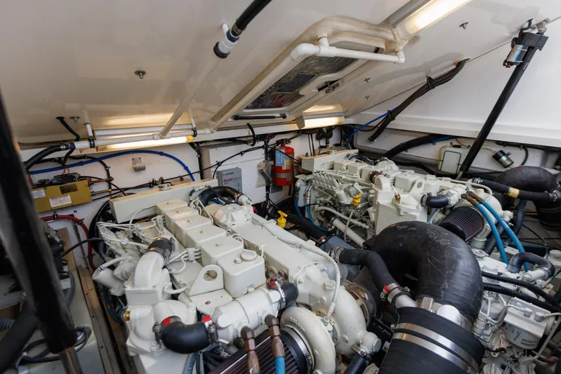 Last Call Yacht Photos Pics Engine room of 2001 Tiara Yachts 3500 Open, showcasing dual engines and mechanical components.