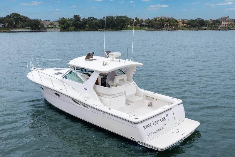 Last Call Yacht Photos Pics 2001 Tiara Yachts 3500 Open cruising on a serene lake with lush shoreline.