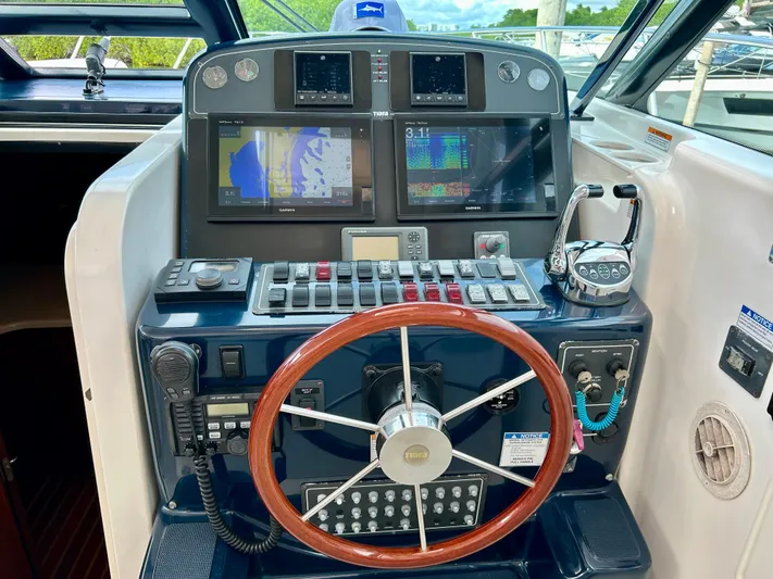 2006 Tiara 3600 Open @ Cancun Yacht Photos Pics Helm of 2006 Tiara Yachts 3600 Open with navigation equipment and wooden steering wheel.