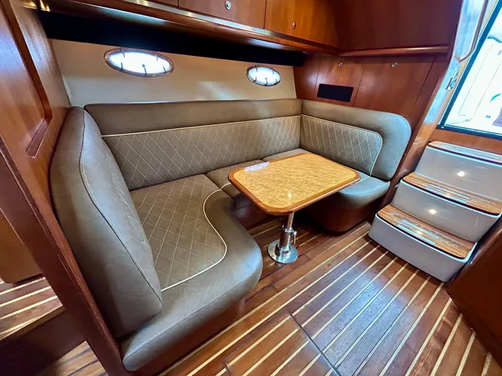 2006 Tiara 3600 Open @ Cancun Yacht Photos Pics 2006 Tiara Yachts 3600 Open interior with elegant seating and wooden table.