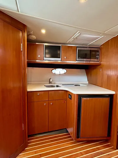 2006 Tiara 3600 Open @ Cancun Yacht Photos Pics 2006 Tiara Yachts 3600 Open kitchen with wood cabinetry and modern appliances.