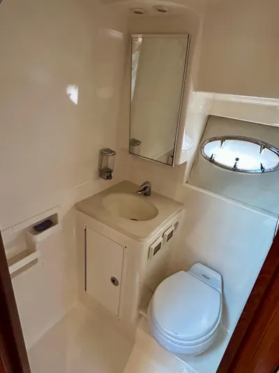 2006 Tiara 3600 Open @ Cancun Yacht Photos Pics 2006 Tiara Yachts 3600 Open bathroom with sink, toilet, and porthole window.