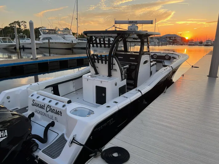 Sunset Chaser Yacht Photos Pics 2023 Tidewater 320 CC Adventure boat docked at sunset, Jacksonville marina.