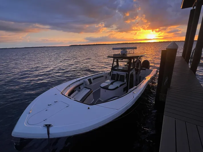 Sunset Chaser Yacht Photos Pics 2023 Tidewater 320 CC Adventure boat at sunset by the dock.