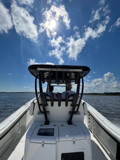 Sunset Chaser Yacht Photos Pics 2023 Tidewater 320 CC Adventure boat cruising under a sunny sky.