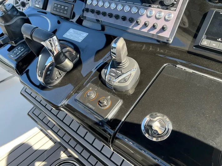 Sunset Chaser Yacht Photos Pics Control panel of 2023 Tidewater 320 CC Adventure boat with joystick and throttle.