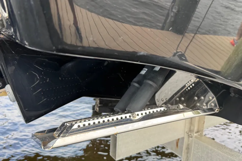 Sunset Chaser Yacht Photos Pics Close-up of 2023 Tidewater 320 CC Adventure boat's trim tab and hull detail.