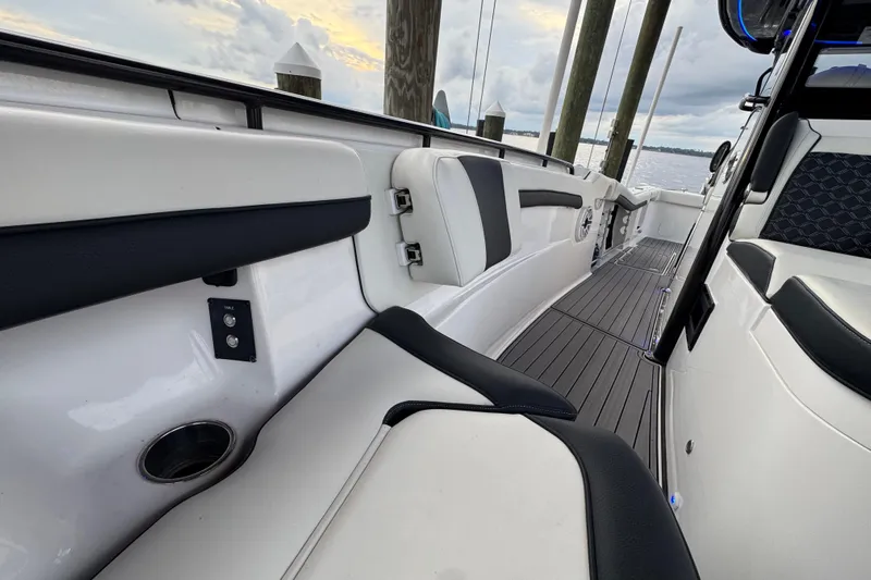 Sunset Chaser Yacht Photos Pics 2023 Tidewater 320 CC Adventure boat interior with sleek seating and modern design.