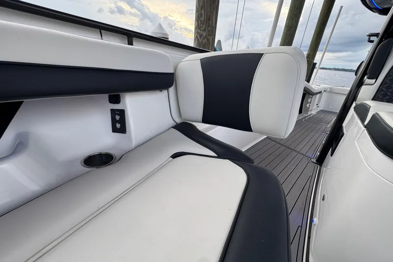 Sunset Chaser Yacht Photos Pics 2023 Tidewater 320 CC Adventure boat interior with cushioned seating and sleek design.