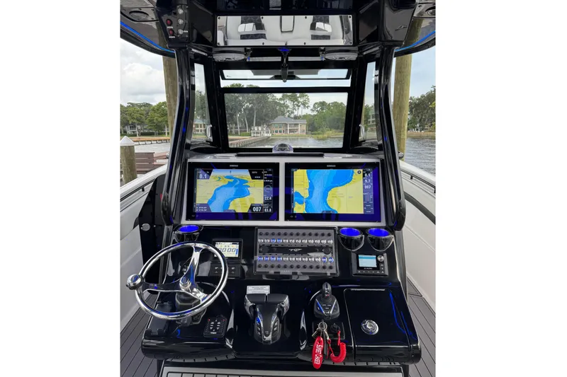 Sunset Chaser Yacht Photos Pics 2023 Tidewater 320 CC Adventure boat dashboard with navigation screens and controls.