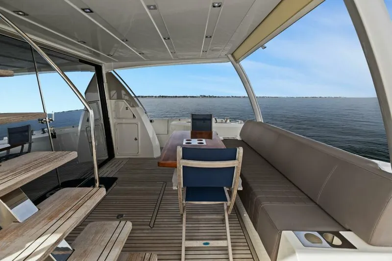 Be As You Are Xl Yacht Photos Pics 2017 Prestige 680 Flybridge yacht deck with seating, table, and ocean view.