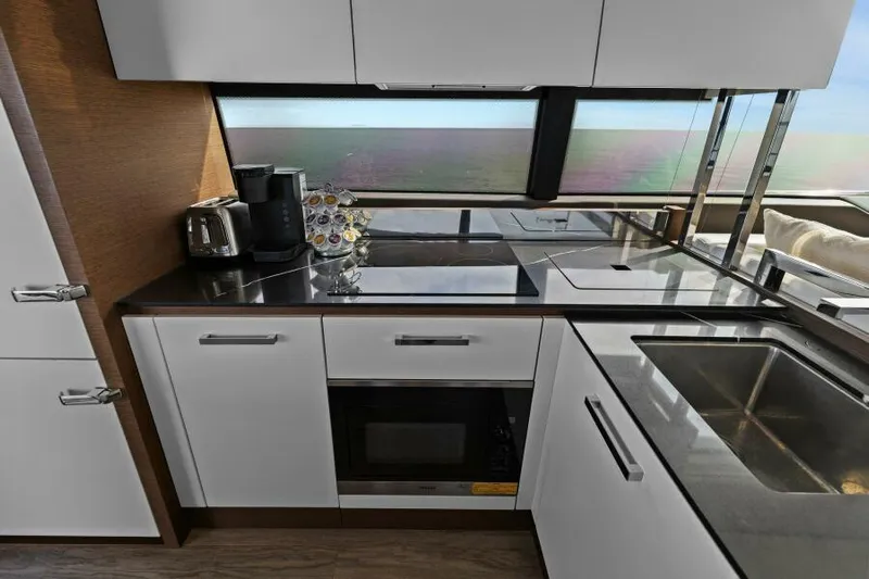 Be As You Are Xl Yacht Photos Pics Modern kitchen interior on 2017 Prestige 680 Flybridge yacht with sleek appliances and countertops.