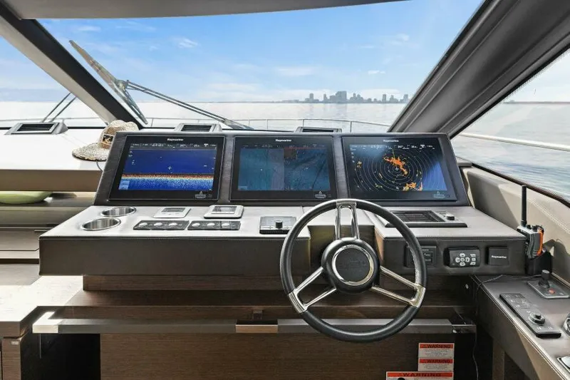 Be As You Are Xl Yacht Photos Pics Helm of 2017 Prestige 680 Flybridge yacht with navigation screens and steering wheel.