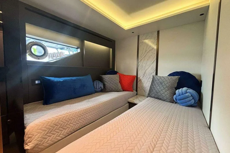  Yacht Photos Pics Luxurious 2024 Explorer EX62 yacht cabin with twin beds, plush pillows, and modern decor.