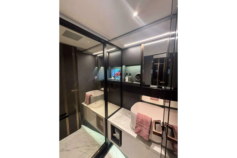  Yacht Photos Pics Luxurious 2024 Explorer EX62 bathroom with modern design, marble flooring, and elegant fixtures.