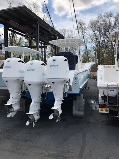  Yacht Photos Pics 2017 Buddy Davis 34 Center Console boat with triple outboard engines, docked outdoors.