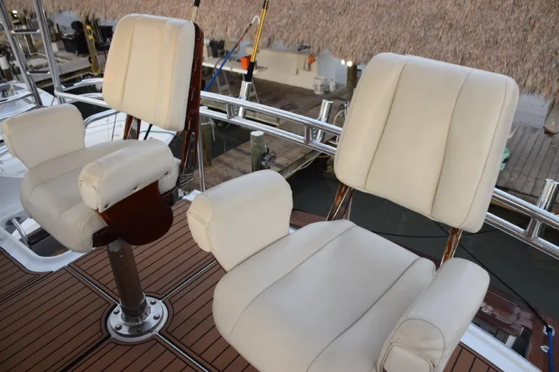 Main One Yacht Photos Pics Two white cushioned captain's chairs on the deck of a 2000 Custom Carolina Wetsig Yachts Cape Fear.