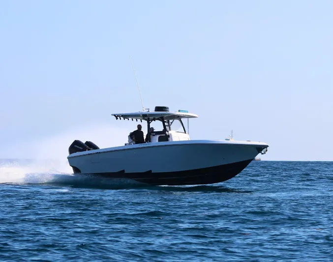  Yacht Photos Pics 2025 Fountain 34 CC boat cruising on open water under clear blue sky.
