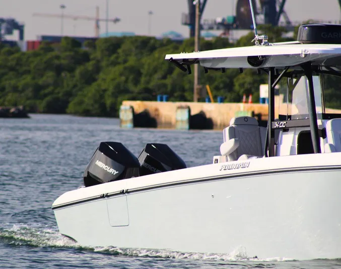  Yacht Photos Pics 2025 Fountain 34 CC boat cruising on water with Mercury engines.