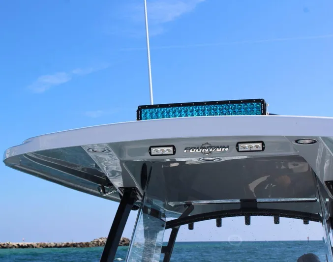  Yacht Photos Pics 2025 Fountain 34 CC boat top view with blue sky and ocean background.