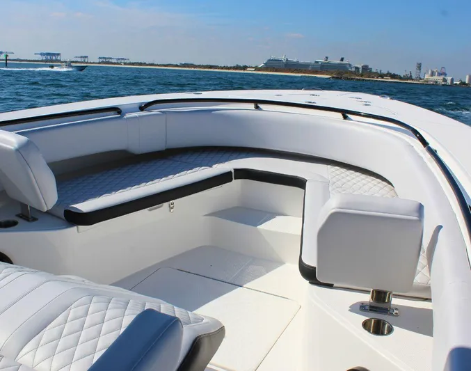  Yacht Photos Pics 2025 Fountain 34 CC boat interior with white seating, on a sunny day at sea.