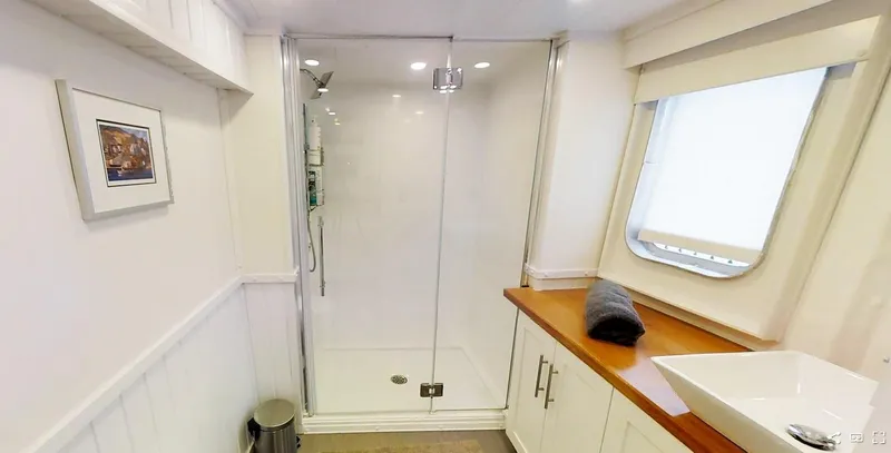  Yacht Photos Pics Modern bathroom on 2004 Custom Bon Pelley catamaran with shower, sink, and window.
