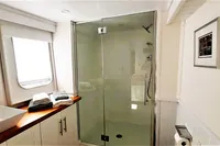 Luxurious bathroom on 2004 Custom Bon Pelley catamaran with glass shower and modern fixtures.