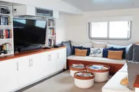 Luxurious interior of 2004 Custom Bon Pelley catamaran with cozy seating and entertainment area.