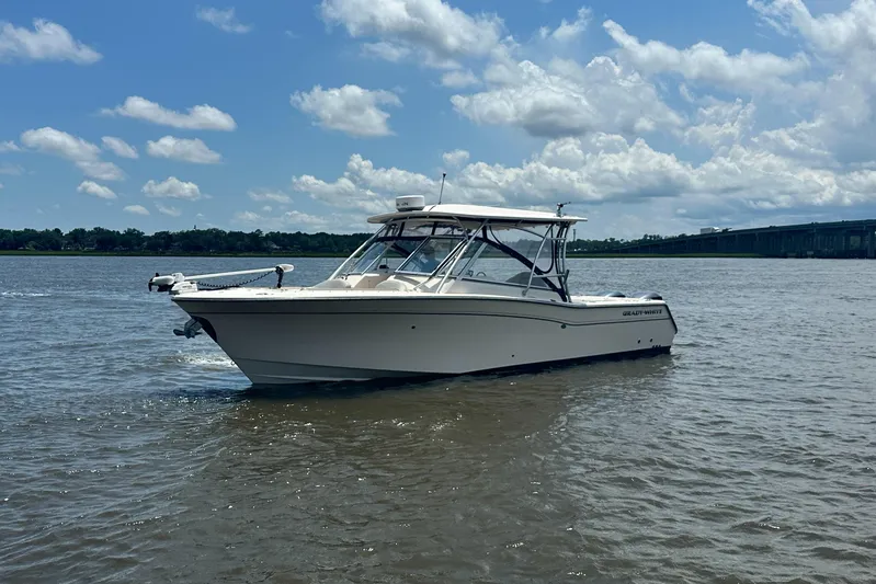  Yacht Photos Pics 2012 Grady-White Freedom 307 boat on calm water under a partly cloudy sky.