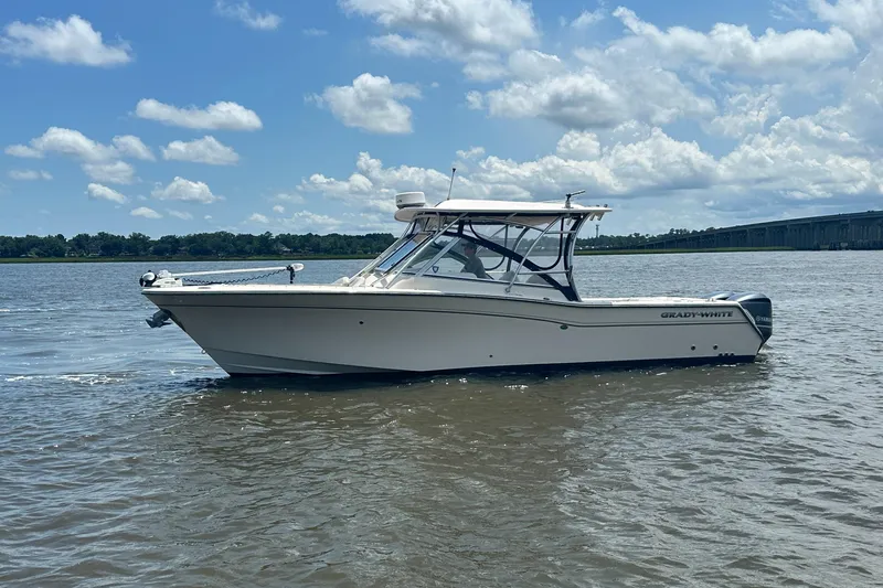  Yacht Photos Pics 2012 Grady-White Freedom 307 boat on calm water under a partly cloudy sky.
