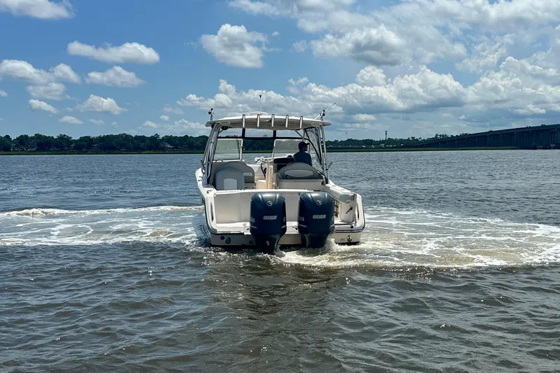  Yacht Photos Pics 2012 Grady-White Freedom 307 boat cruising on a sunny day with clear skies.