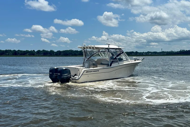  Yacht Photos Pics 2012 Grady-White Freedom 307 boat cruising on a sunny day with Yamaha engines.