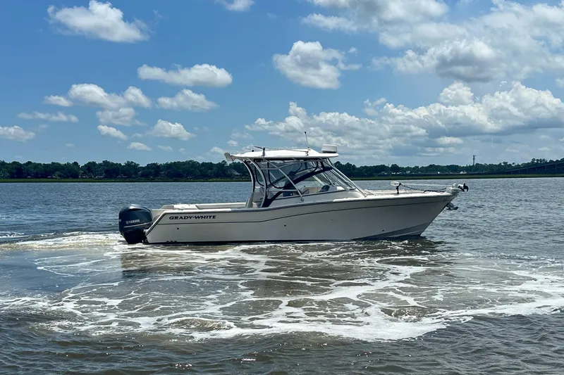  Yacht Photos Pics 2012 Grady-White Freedom 307 boat cruising on a sunny day with blue skies.