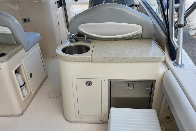  Yacht Photos Pics 2012 Grady-White Freedom 307 boat interior with sink and seating area.