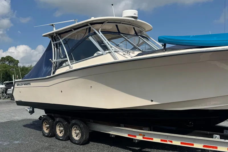  Yacht Photos Pics 2012 Grady-White Freedom 307 boat on trailer under blue sky.